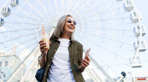 Portrait of smiling young businesswoman holding umbrella