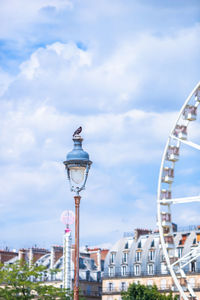 Low angle view of ferris wheel in city