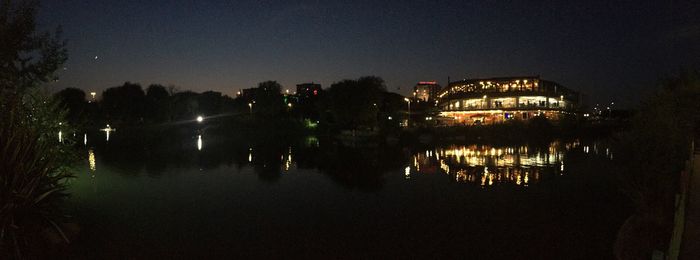 Reflection of illuminated buildings in water at night