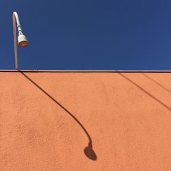 Low angle view of basketball hoop against clear blue sky