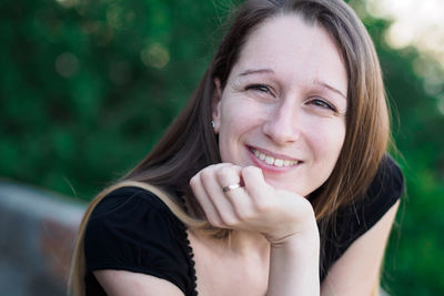 Close-up portrait of smiling young woman