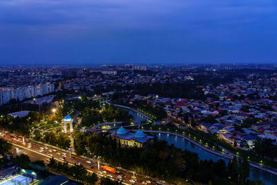 High angle view of illuminated cityscape against sky