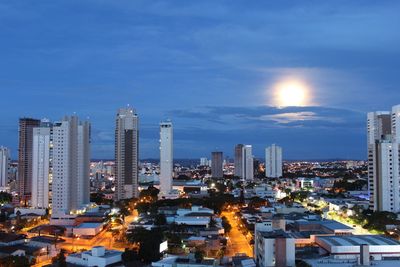 Illuminated cityscape against sky