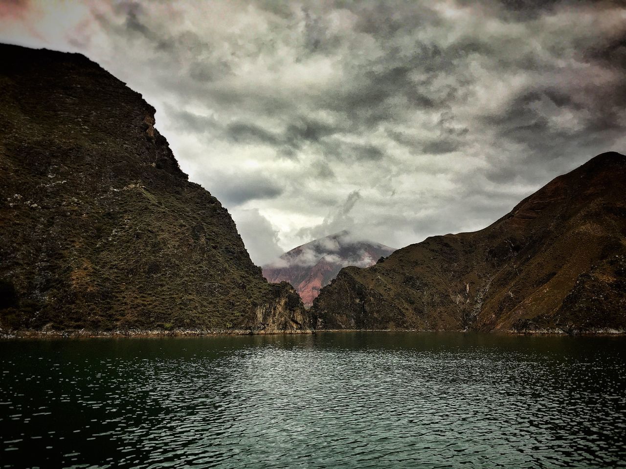 mountain, tranquil scene, scenics, water, tranquility, waterfront, lake, mountain range, beauty in nature, cloud - sky, sky, nature, non-urban scene, cloud, remote, majestic, cloudy, outdoors, day, no people, atmospheric mood