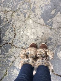 Low section of woman wearing boots while standing on street