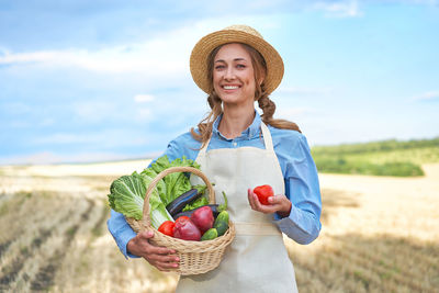 Portrait of smiling young man holding basket