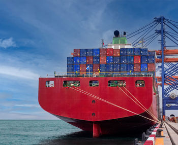 The container vessel during discharging at an industrial port.