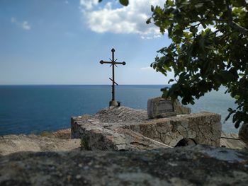 Built structure by sea against sky