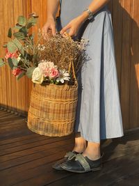 Cropped hand of woman sitting on table