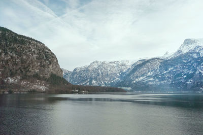 Scenic view of lake and snowcapped mountains against sky