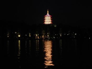 Illuminated building against sky at night