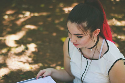 Close-up of young woman using smart phone