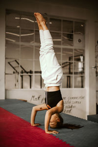 Full length of woman exercising in gym