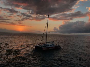 Sailboat on sea against sky during sunset