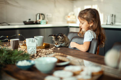 Happy young woman with cat at home