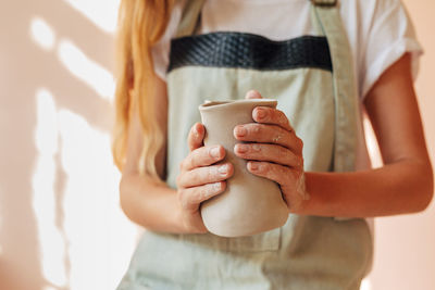 Close-up of woman holding coffee cup