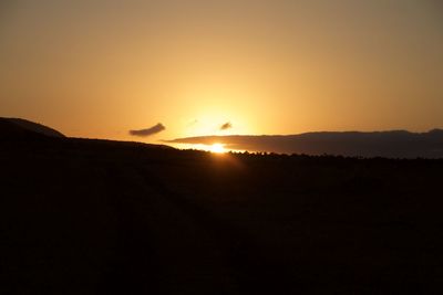 Scenic view of silhouette landscape against clear sky during sunset