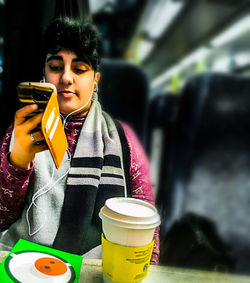 Young woman holding coffee cup