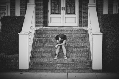 Full length of woman standing in front of building