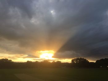 Scenic view of dramatic sky over landscape during sunset