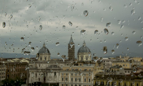 Full frame shot of wet glass window in city