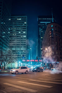 Illuminated city buildings at night