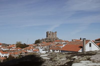 Buildings in town against sky