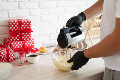 Midsection of man preparing food on table