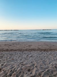 Scenic view of beach against clear blue sky
