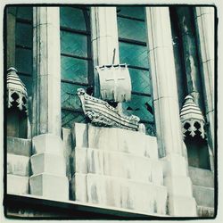 Low angle view of bird perching on building