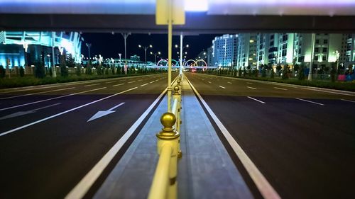 Illuminated road in city at night