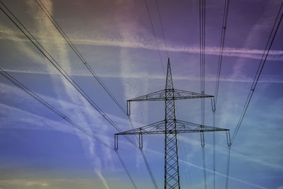 Low angle view of electricity pylon against sky