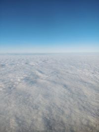 Aerial view of landscape against clear blue sky