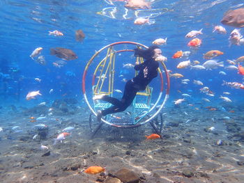 Full length of woman diving under sea