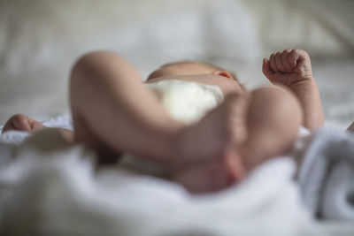 Close-up of baby sleeping on bed