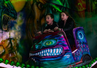 Cute siblings sitting in ride