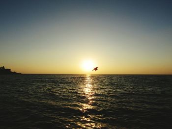 Scenic view of sea against clear sky during sunset