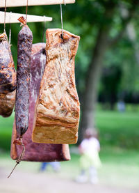 Close-up of smoked bacon hanging outdoors