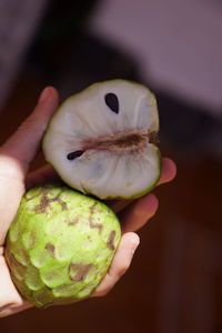 Close-up of hand holding fruit