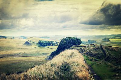 Scenic view of landscape against cloudy sky