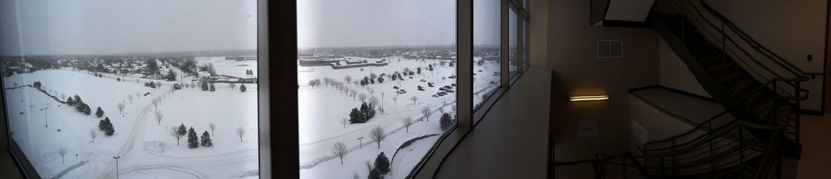 Panoramic shot of cars on snow covered window