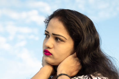 Portrait of beautiful woman against sky