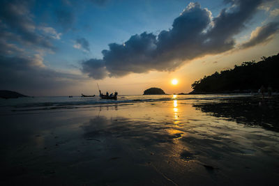 Scenic view of beach against sky during sunset
