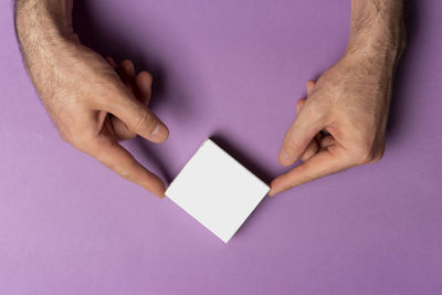 Cropped hand of woman holding paper