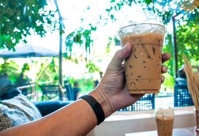 Close-up of hand holding drink