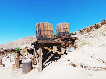 Old rusty wheel against clear blue sky