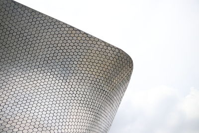 Low angle view of roof against cloudy sky