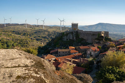 View of sortelha castle and antique stone houses and wind turbines, in portugal