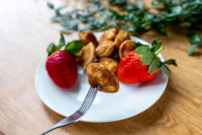 Close-up of strawberries in plate on table