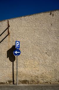 Information sign against blue sky